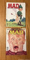Front covers of both MAD magazines