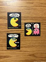 Fronts of three Pac-Man stickers with captions