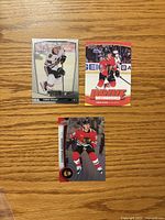Front view of three Connor Bedard cards