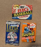 Three sealed baseball card packs: Topps Big, Fleer 91 Ultra, Donruss
