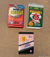 Front view showing three sealed baseball card packs: Donruss 1988, Score 1991 Series 1, Pacific 1990 Senior League