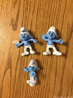 Front view of three Smurf figures showing character details and condition