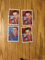Fronts of four promo hockey cards laid out on wood surface