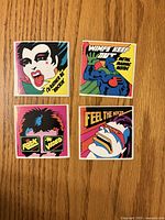 Front view of four 1985 Topps Heavy Metal stickers showing artwork and slogans