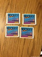 Front view of four sealed Panini Hockey '95-'96 sticker packs