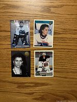 All four Manon Rhéaume hockey cards laid out on wood surface, showing fronts clearly