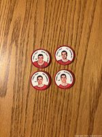 Overview of the four Montreal Canadiens hockey coins laid out on wooden surface