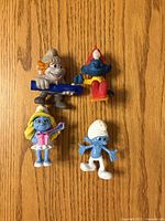 Front view of four Smurf figurines