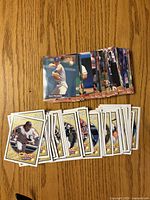 Stacks of Upper Deck Heroes and Fleer Ultra baseball cards displayed on wood surface