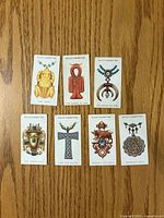 Fronts of seven Wills Lucky Charms cards displayed on wood surface