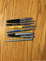 All eight Sheaffer ballpoint pens laid out showing colours, caps, clips, and overall condition