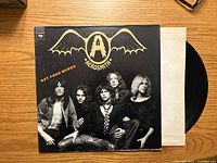 Front cover of Aerosmith "Get Your Wings" LP with record partially visible
