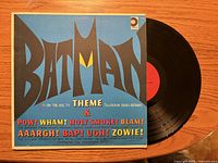 Front of Batman Theme album sleeve with vinyl partly visible