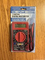 Front view of sealed Cen-Tech digital multimeter with leads visible