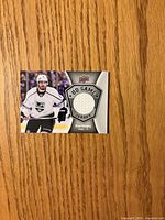 Front of Drew Doughty UD Game Jersey card showing photo and fabric swatch
