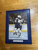 Front view of framed Edmonton Oilers print with title visible