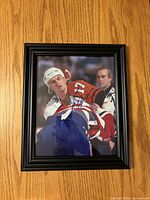 Front view showing signed Guillaume Latendresse photo in black frame