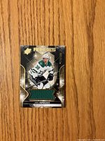 Front of Joel L’Esperance rookie jersey card with green jersey swatch