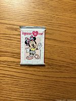 Front of sealed Minnie 'n Me trading card pack showing artwork and card count