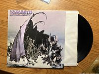 Front jacket showing title and artwork with vinyl partially removed