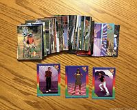 Fronts of stacked trading cards and three bonus cards displayed