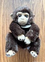 Front view of brown plush monkey with Yomiko Classics chest tag visible