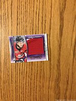 Front of Ryan Strome jersey card with red swatch