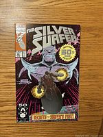 Front cover of Silver Surfer #50 comic showing title, Thanos, anniversary seal