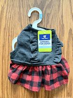 Front view of grey bodice and plaid skirt dog dress on hanger with tag