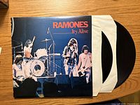 Front cover with vinyl records partly out of sleeve