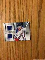 Front of Showcase Standouts Tom Wilson jersey card with fabric swatch