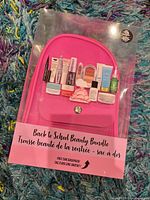 Front of boxed set showing pink backpack and sample images