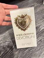 Front of sealed perfume box showing Devotion heart emblem