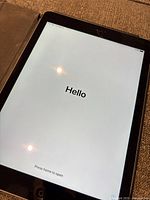 iPad front powered on displaying Hello setup screen