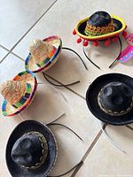 Five rigid sombrero headbands on tile floor