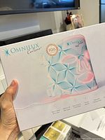 Retail box front showing Omnilux Contour Face mask graphics
