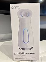 Front view of boxed PMD SilkSteam Pro facial steamer