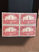 Front view of four unused 3¢ red 1927 Canada Parliament stamps in block format
