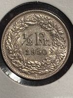Reverse of 1950 Swiss 1/2 franc coin showing denomination within wreath
