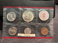 Front view of sealed six-cell Denver Mint pack showing all coins and token