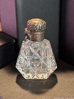 Full view of cut-glass perfume vial with sterling cap