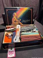 Open Pot Of Gold tin with assorted sewing notions visible