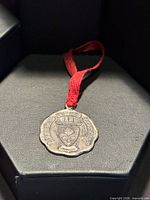Obverse of sterling medal with school crest and ribbon