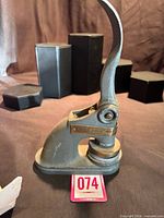 Full side view of cast iron embosser showing overall form and size reference