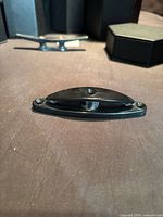 Close-up of one cleat showing mounting holes and overall condition