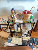 Shelving unit with assorted paints, brushes, basket and supplies