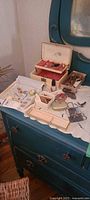 Overall view of dresser with jewelry boxes open showing contents and loose pieces