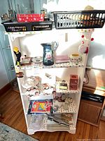 Overview of shelf contents including tin, washboard, pitcher, comics and assorted items
