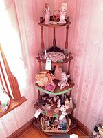 Full view of four-tier corner shelf in room corner