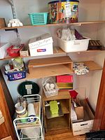 Shelf with tin, tubs, boxes, ceramic piece and other supplies
